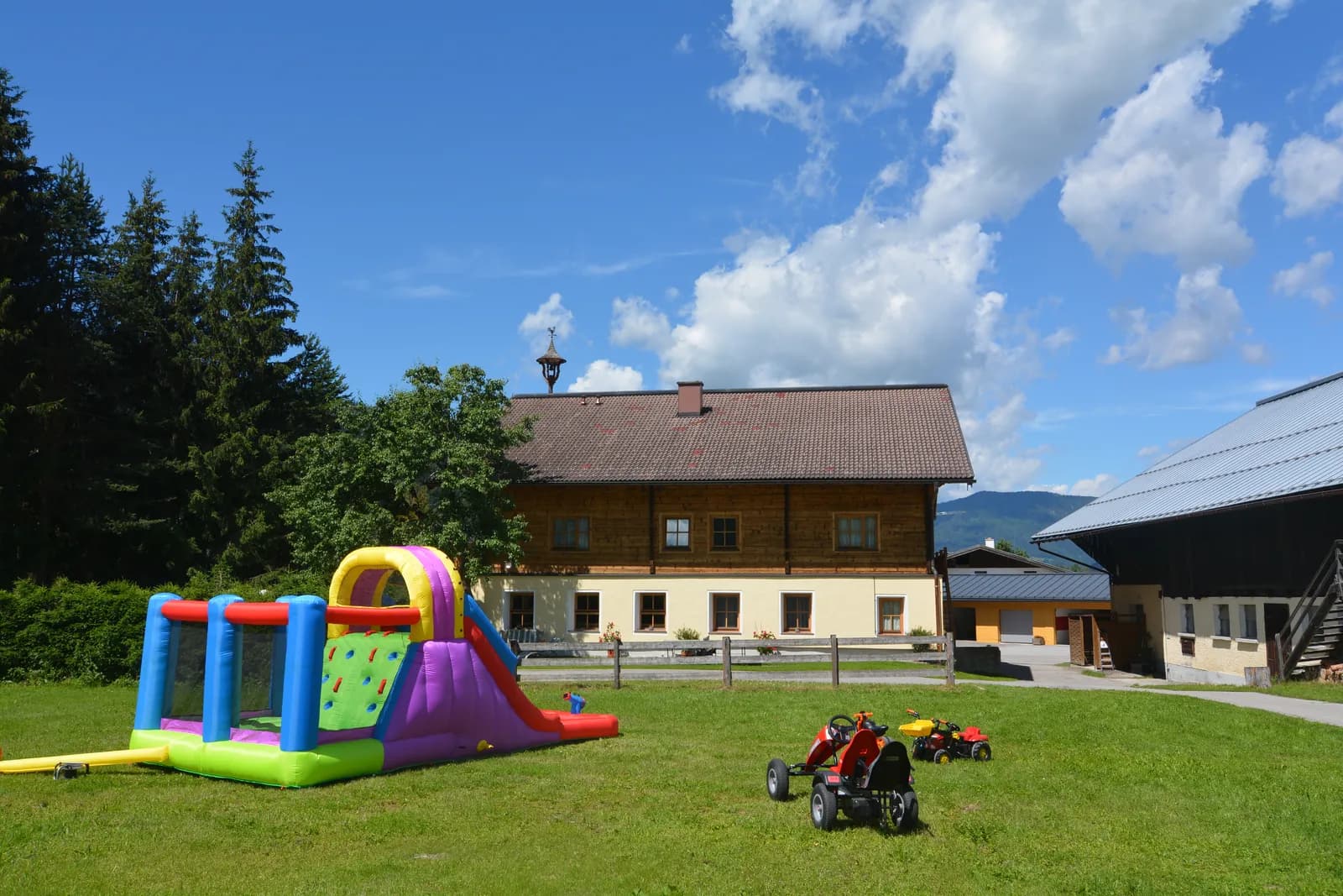 Water bouncy castle and go-kart on the lawn at the farm