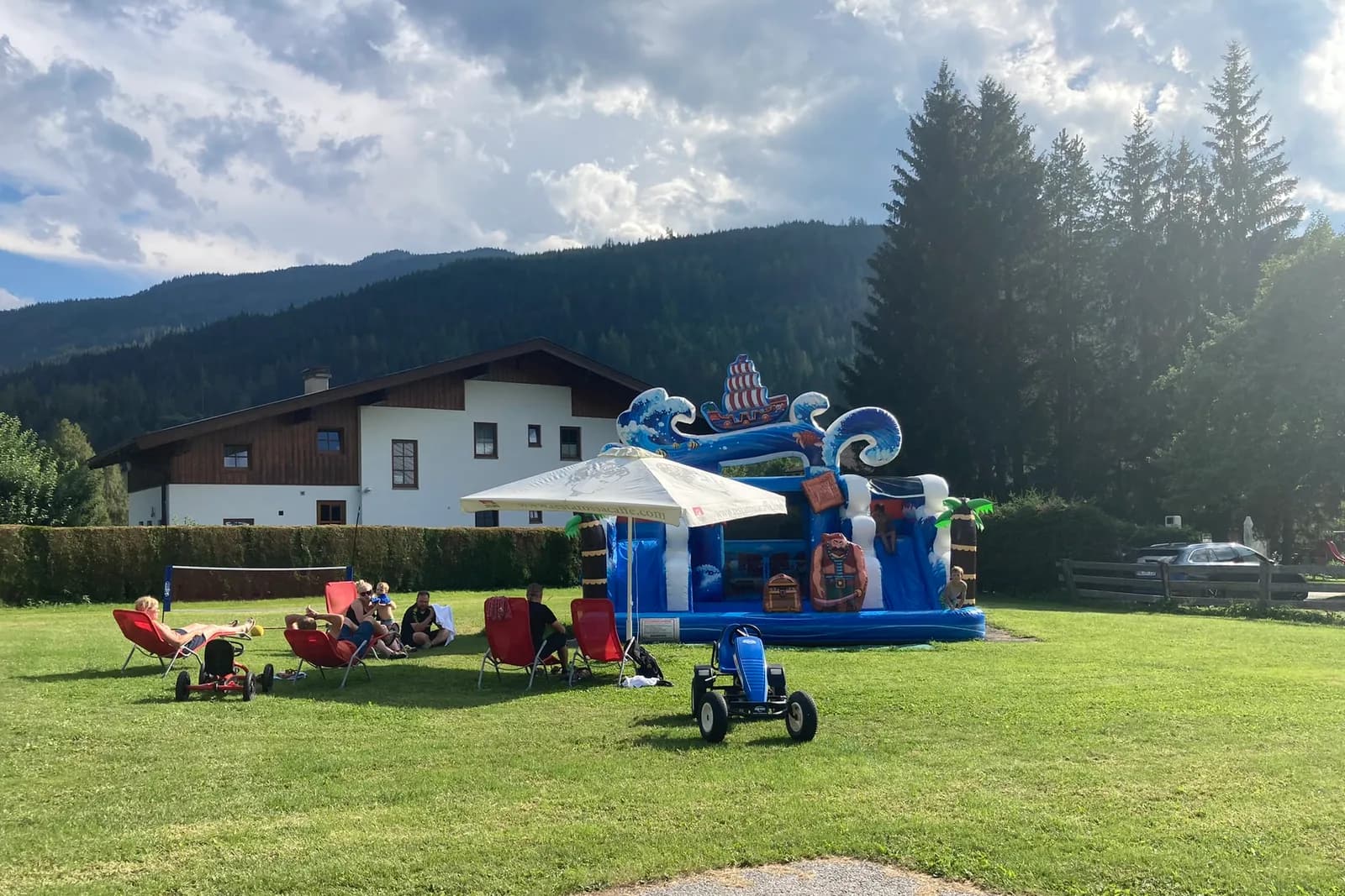 Water bouncy castle and go-kart on the lawn at the farm