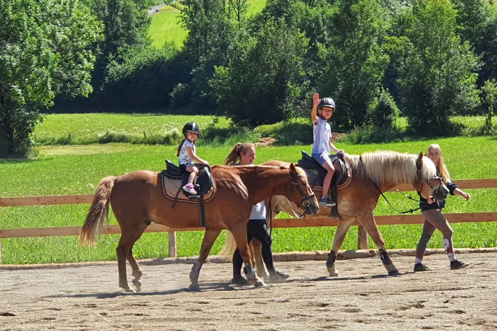 Kinder bei einer geführten Reitstunde am Reitplatz