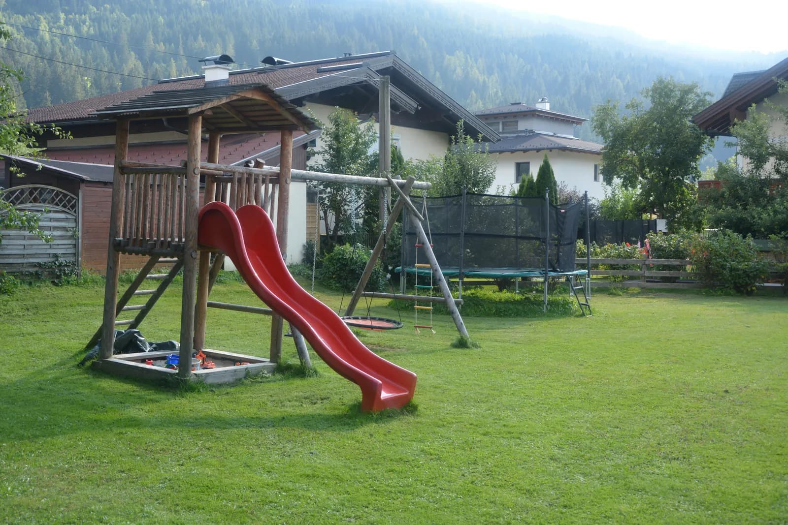 Playground with slide and trampoline at the holiday farm