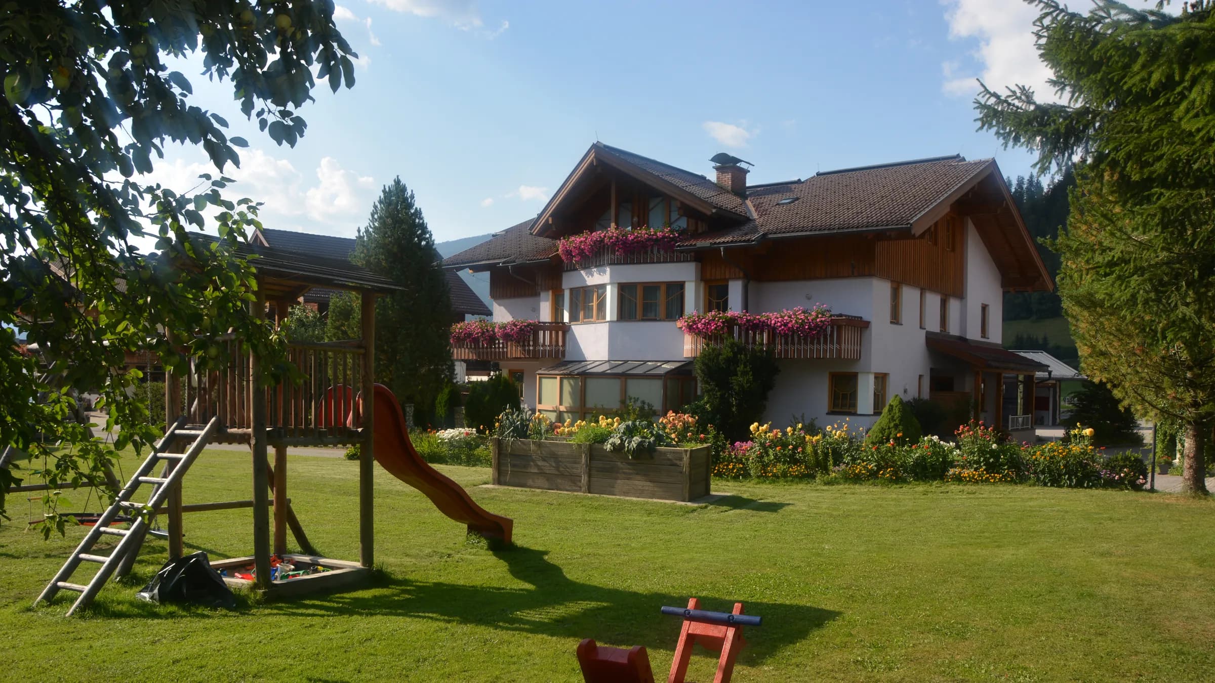 Sun terrace with flowers at the Kasparbauer holiday farm