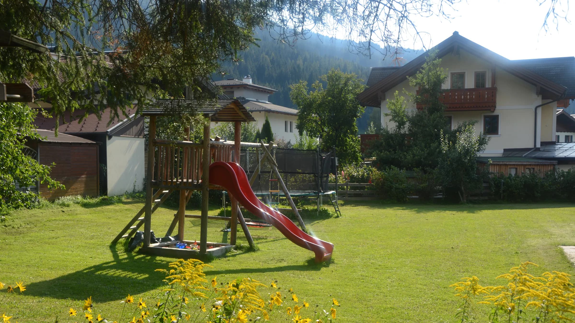 View across the lawn towards the two guest houses of the Kasparbauer holiday farm