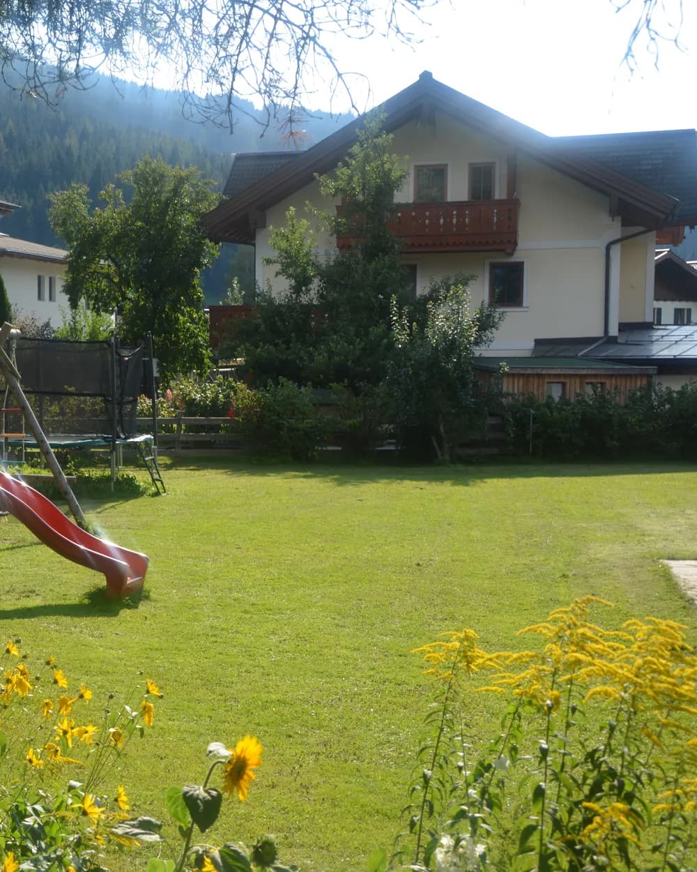 Children playing on the lawn at the Kasparbauer holiday farm in summer